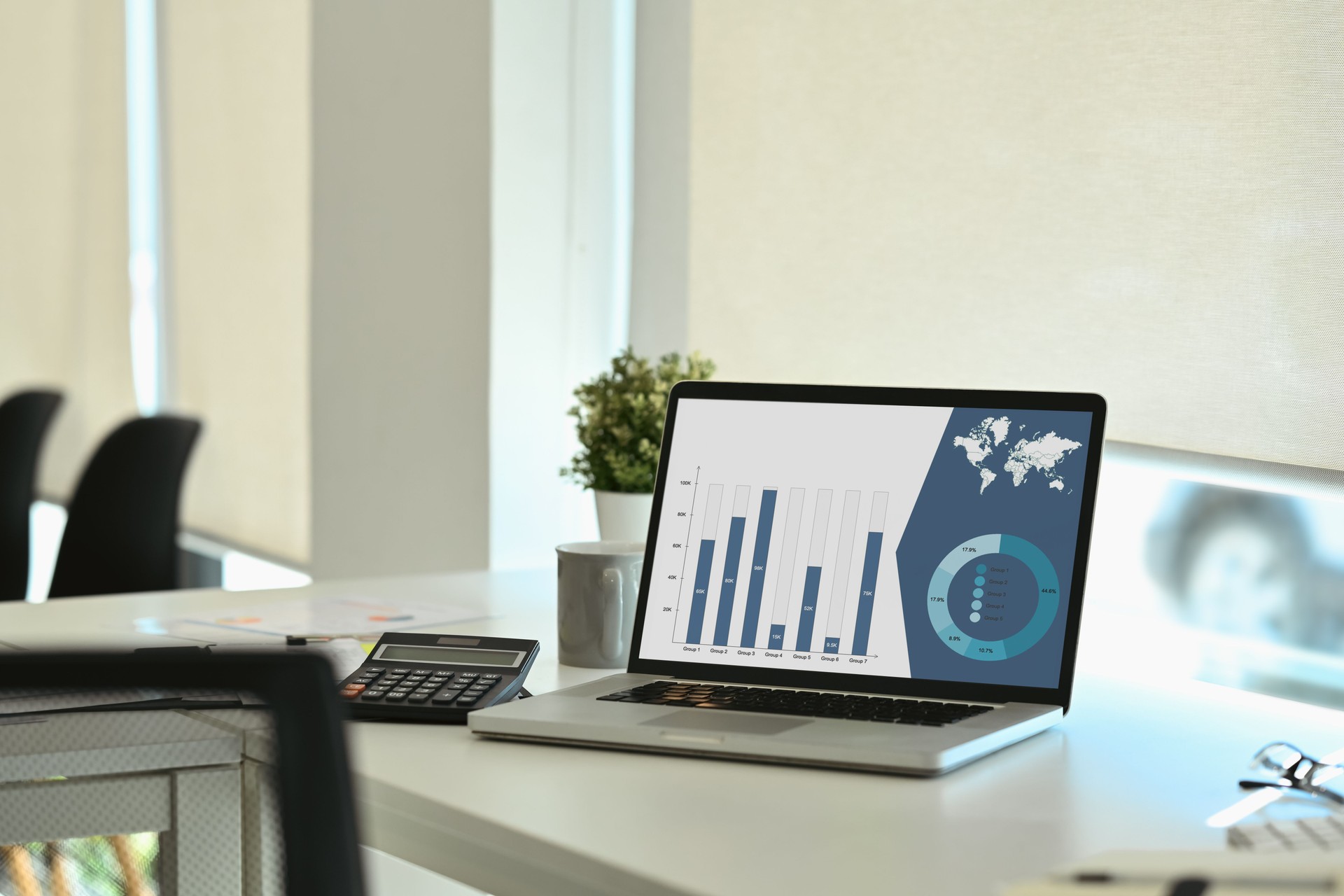Laptop computer analysis business data on office table.